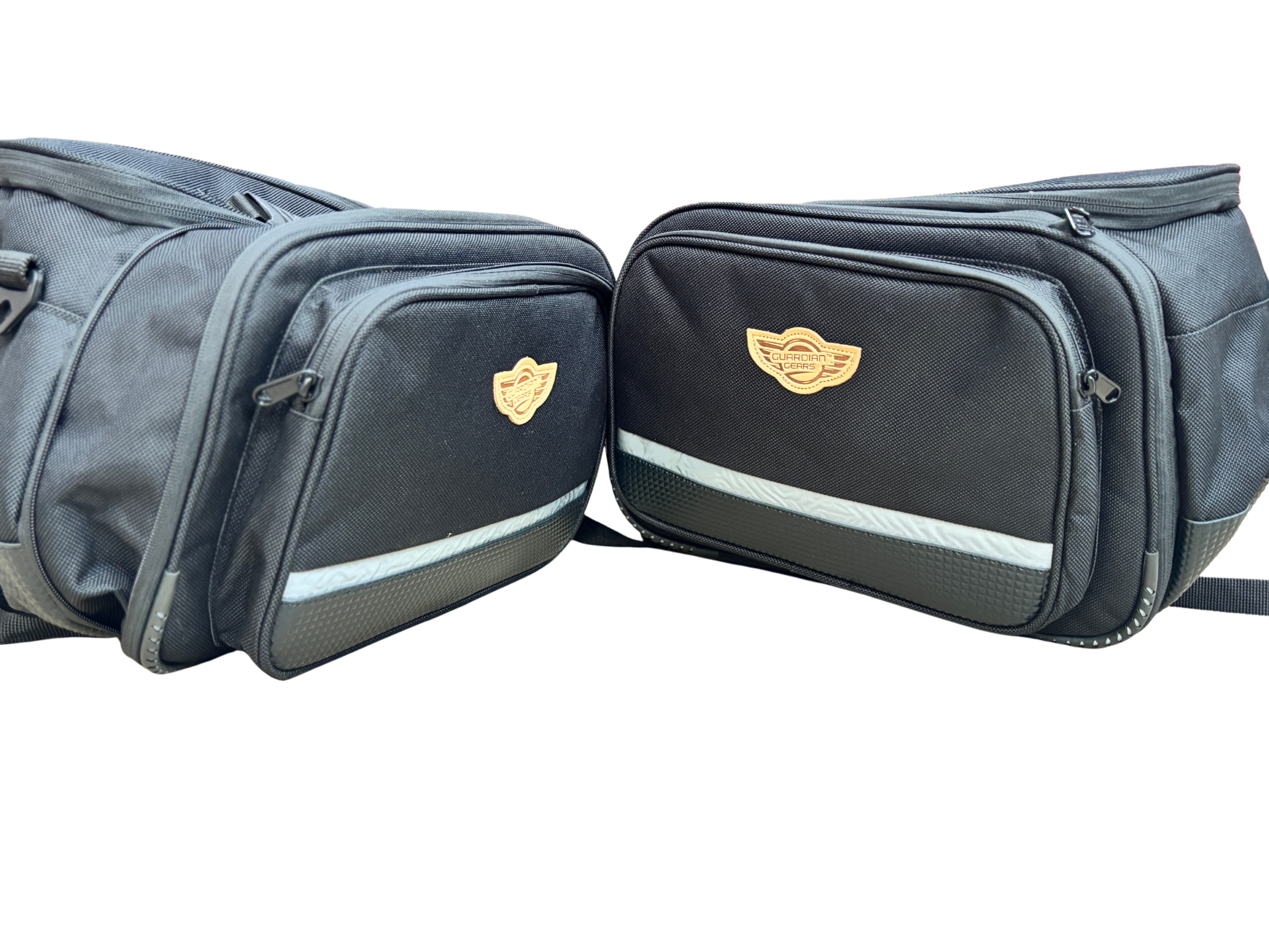 Two black travel bags with a tan guardian gear logo patches side by side on a white background highlight the brand decal and zippered pockets.