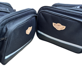 Two navy travel bags joined edge-to-edge, showing beige Guardian Angels logos on each bag.
