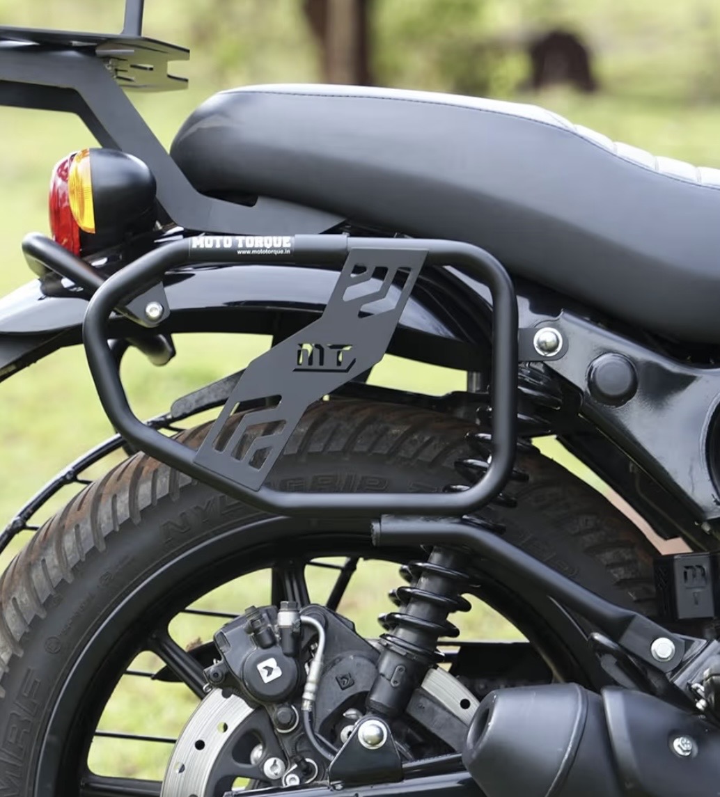 Rear motorcycle with a black frame rack mounted over the rear wheel; visible MT logo on the rack and a gray seat.