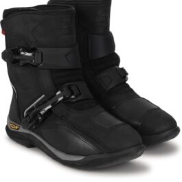 Pair of black ski boots with multiple buckles and rugged sole, shown from a side angle for winter sports use.