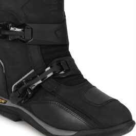 Close-up of a black rugged boot showing two metal buckles and a thick sole at the heel area