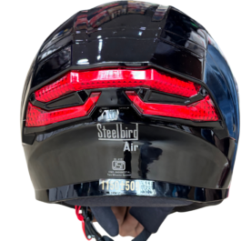 Rear view of a glossy black Steelbird Air motorcycle helmet with a red taillight stripe.
