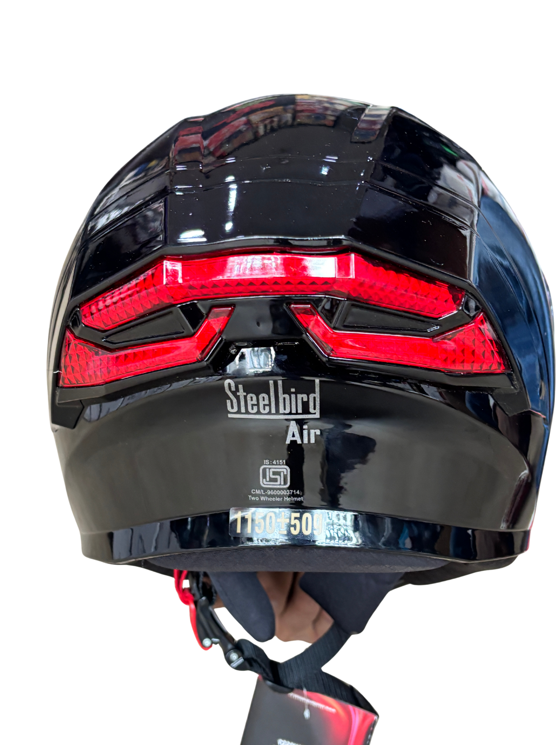 763d32f1-f537-474f-836f-ca98d27aa6f0 - laxmiautocare.com Rear view of a glossy black Steelbird Air motorcycle helmet with a red taillight stripe.