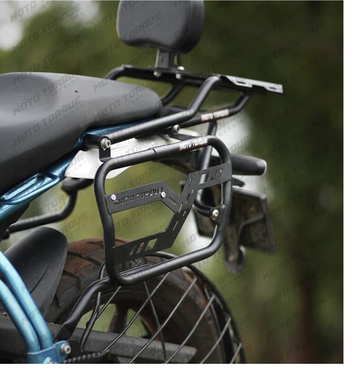 Rear cargo rack and pannier frame mounted on a motorcycle, with a small backrest above the seat outdoors