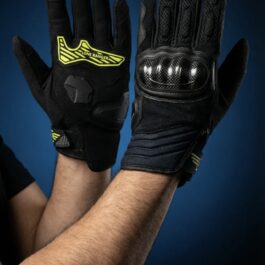 Screenshot - laxmiautocare.com Pair of black protective gloves raised for a high-five against a blue backdrop; one glove shows bright yellow Lone Ranger logo and armor-like padding on the knuckles.