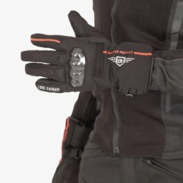Screenshot - laxmiautocare.com Black winter glove with an orange stripe, showing Lone Ranger branding and a small winged emblem on the wrist area, worn by a person in a dark jacket.