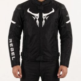 Screenshot - laxmiautocare.com Front view of a black motorcycle jacket with a white stylized emblem on the chest; armor pads on shoulders and white 'REBEL' lettering on the left sleeve.