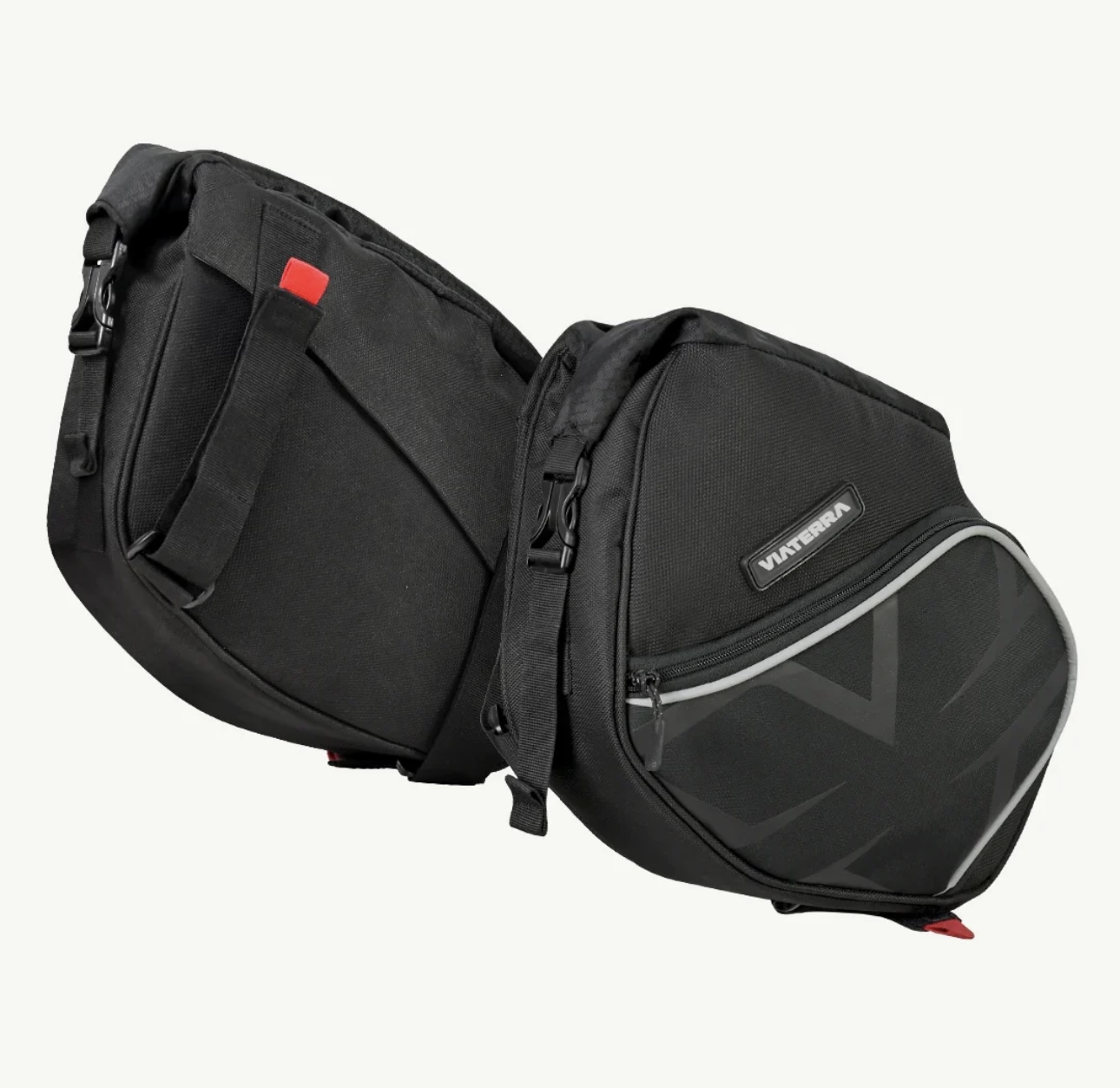 Screenshot - laxmiautocare.com Dual black motorcycle pannier bags attached together, with red zipper pulls and a small front pocket.
