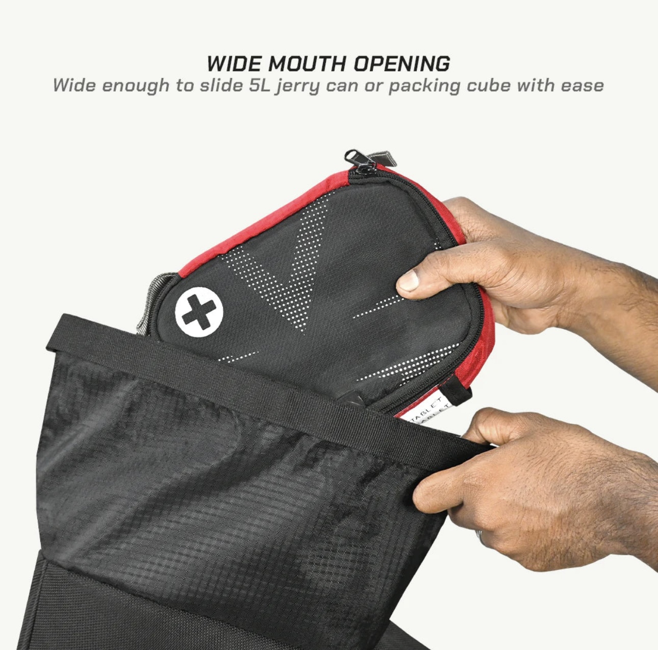Screenshot - laxmiautocare.com Hands insert a red-zippered pouch into a black bag, illustrating the wide-mouth opening feature.