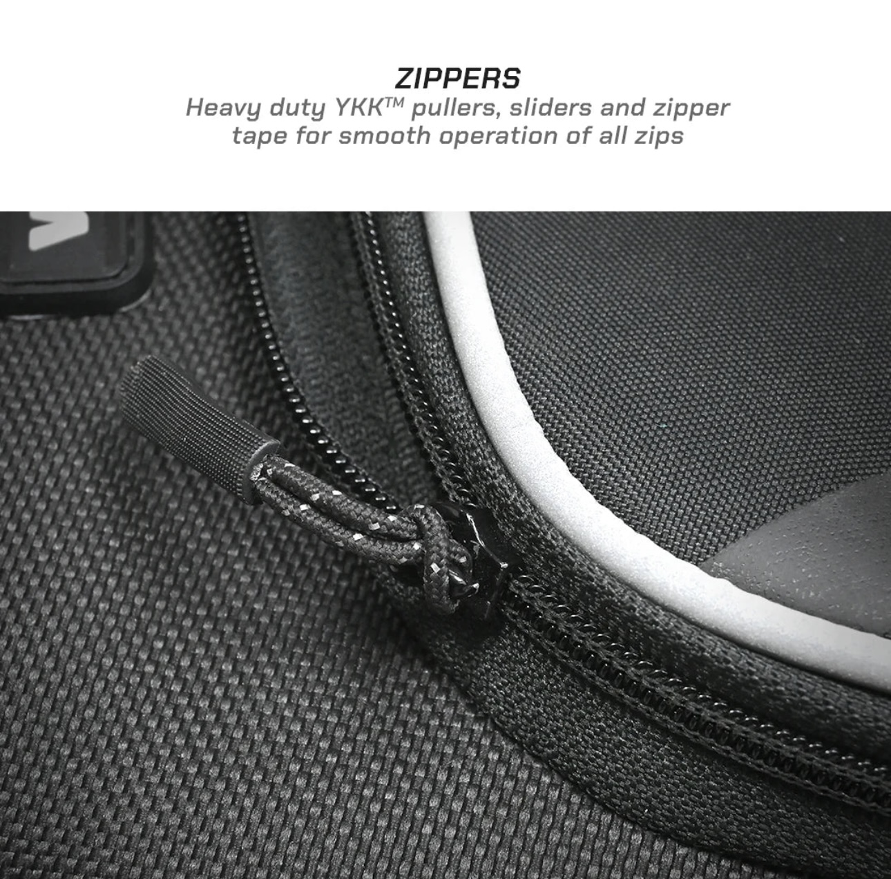 Screenshot - laxmiautocare.com Close-up of a black bag zipper with a fabric puller on textured material.