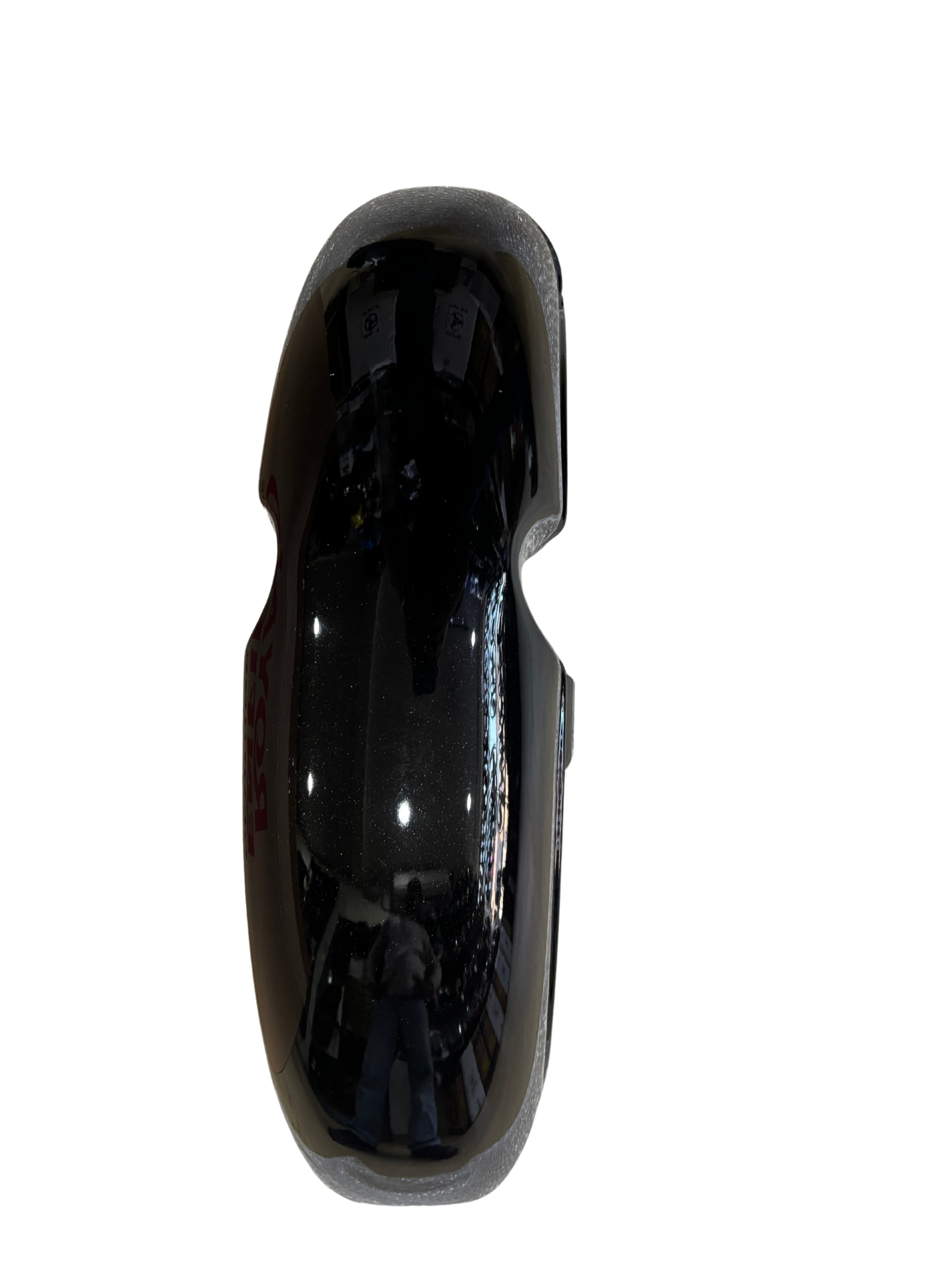 df8debbf-7794-432f-9338-a504e8ba1ac3 - laxmiautocare.com Close-up of a glossy black helmet shell with a foam edge, shown from the side.